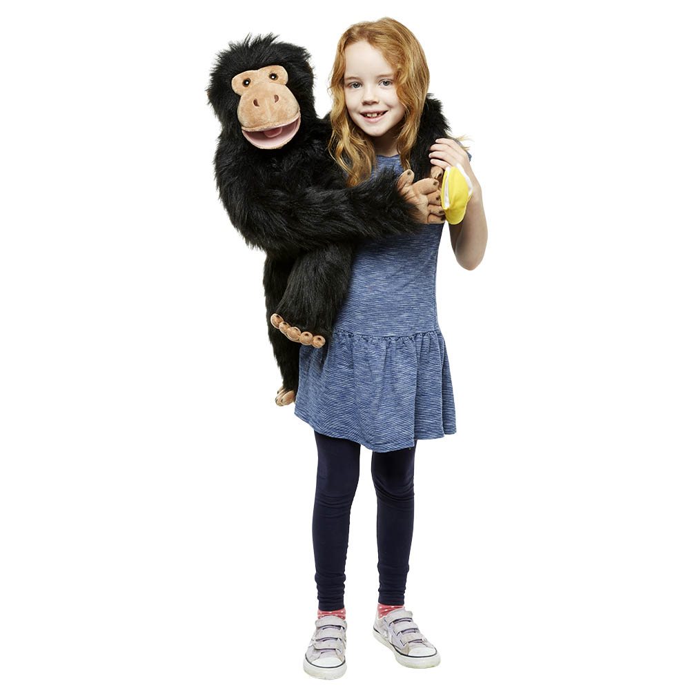 Girl holding the The Puppet Company giant chimpanzee hand puppet in her arms, usage example