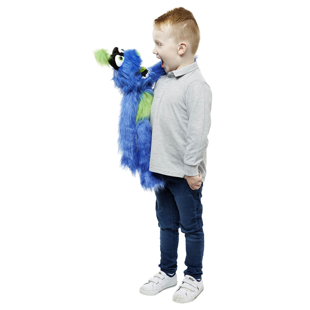 Boy wearing the The Puppet Company blue-green monster hand puppet on his arm, mouth wide open, usage example