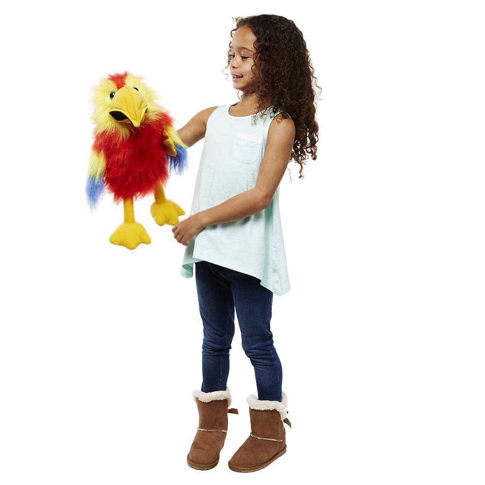 Girl holding the The Puppet Company scarlet macaw hand puppet on her hand, usage example