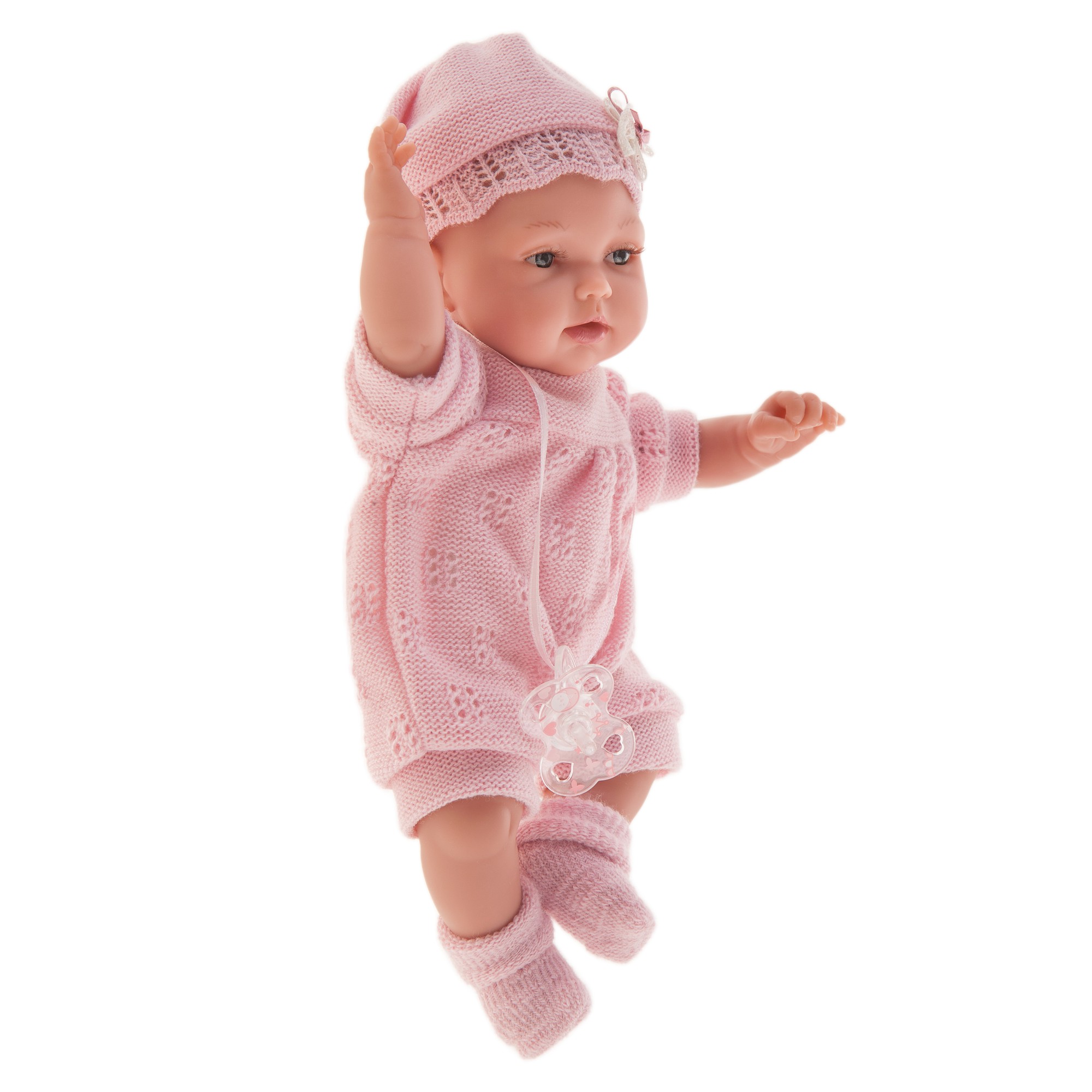 Antonio Juan baby doll Peke, realistic doll in a pink knit outfit, side view with arm raised overhead against a white background