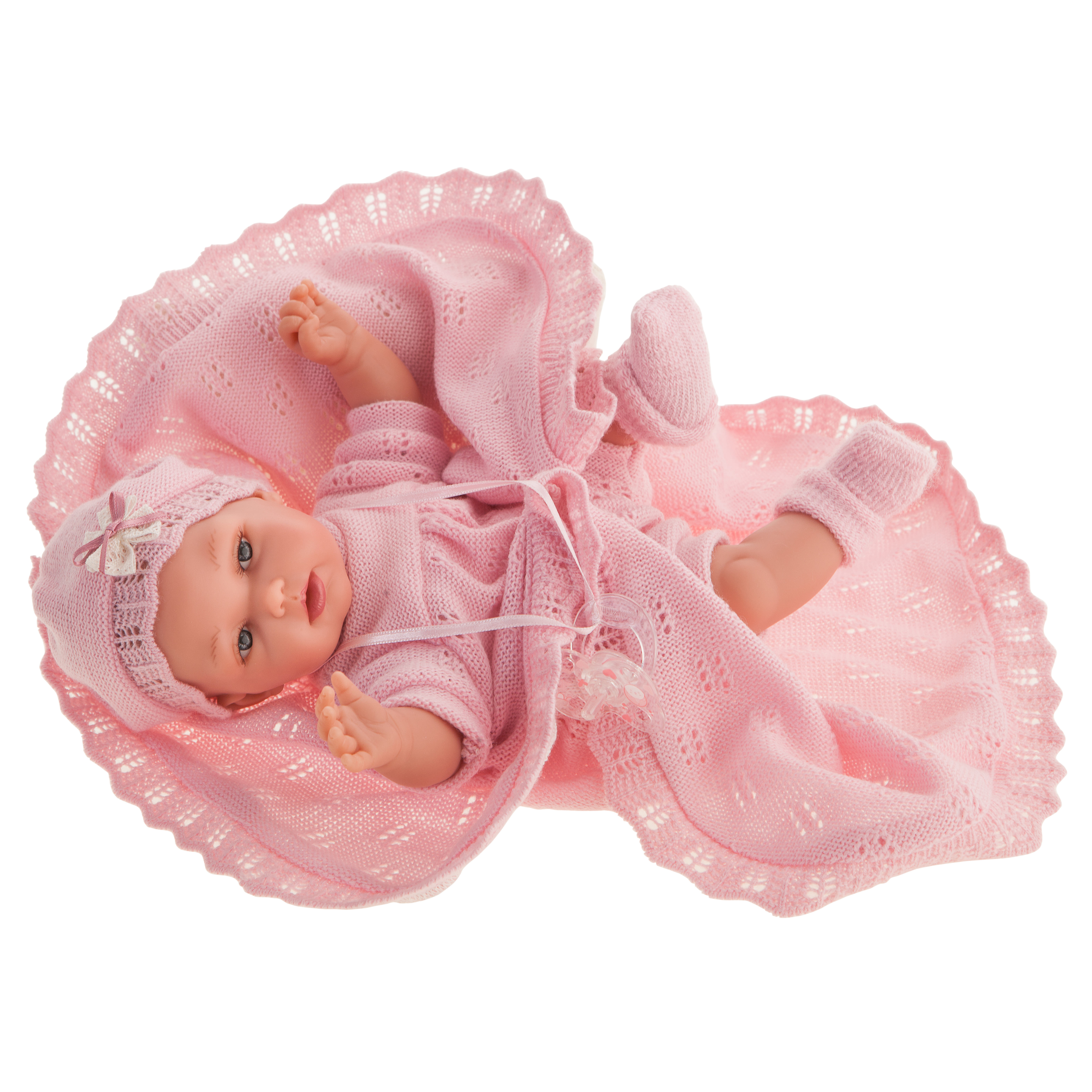 Antonio Juan baby doll Peke, realistic doll in a pink knit outfit with bonnet and booties, lying on an unfolded pink blanket