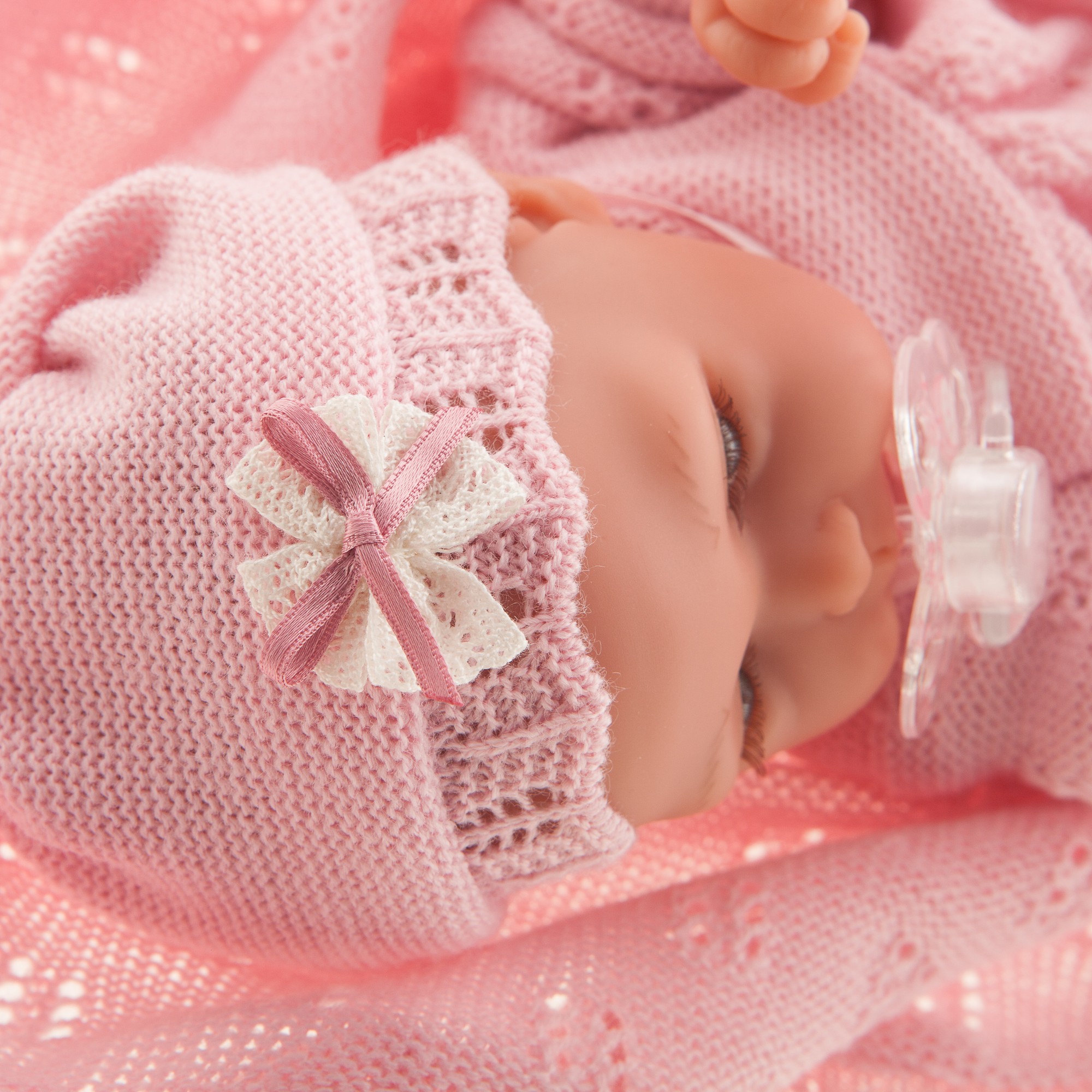 Antonio Juan baby doll Peke, sleeping face with pacifier, pink bow bonnet, wrapped in the cuddly blanket