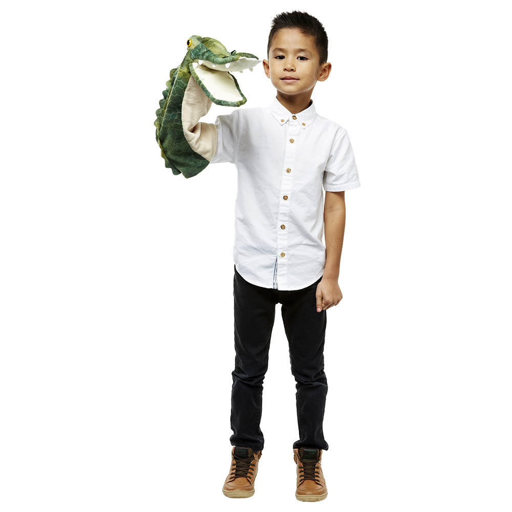 Boy holding the The Puppet Company crocodile hand puppet on his hand, usage example