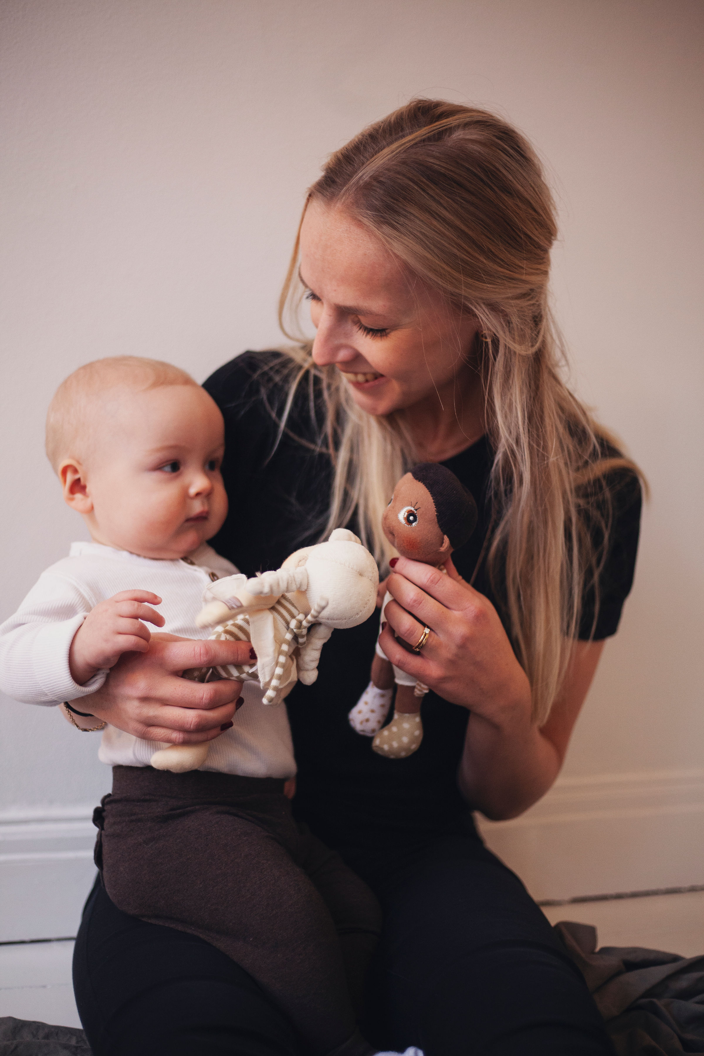 Woman and baby playing with the Rubens EcoBuds mini dolls